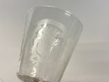 a glass that has a picture of a man on it