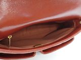 the inside of a brown leather purse with a zipper open