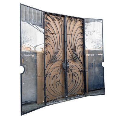 a large metal gate with a decorative design on it