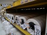 many rolls of paper on the shelves in the store