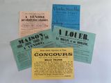 several old french pamphlets are displayed on a white surface