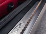 a close up of a car door handle with a red suitcase