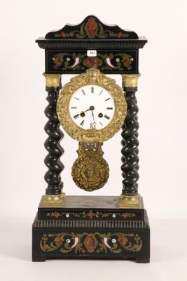 a black and gold clock sitting on top of a table