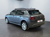 grey citrole car parked in a showroom with white walls