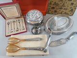 many silverware items sitting on a table with a red box