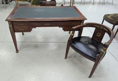 a desk and chair in a room with a lot of chairs