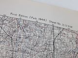 a map on the wall with a glass of wine on it