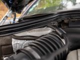 a close up of a car ' s engine with its hood open