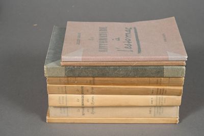 several books stacked on top of each other on a table