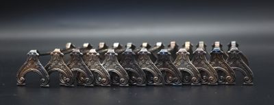 a group of silver figurines sitting on a black surface