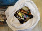 a bag full of pens and pencils sitting on a table