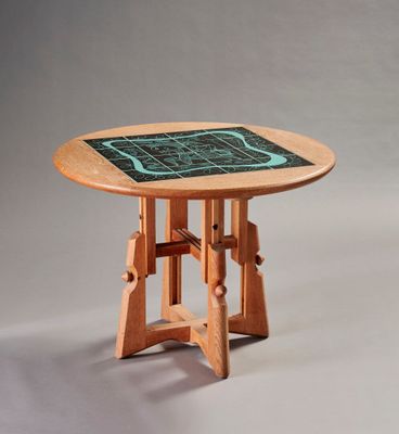 a wooden table with a green tile on top of it