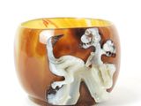 a brown and white bowl with an elephant and flowers on it