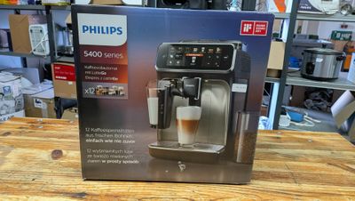 La boîte d'une machine à café est posée sur une table en bois.
