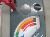 a meter that is on a table with wires