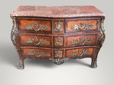 a chest of drawers with a marble top on it