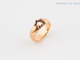 a close up of a gold ring with a diamond on it