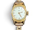 une montre-bracelet en or avec un cadran blanc
