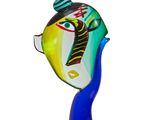 a glass sculpture of a fish with a tie on it