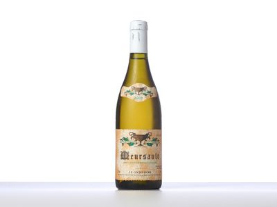 a bottle of white wine sitting on top of a table
