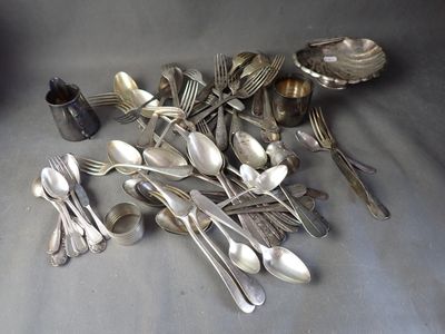 a lot of silver spoons and silverware on the table