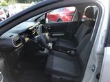 the interior of a car with the door open and the driver ' s seat down