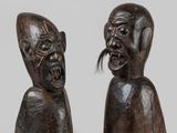 a pair of carved wooden figures of a man and a woman