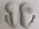 two wii controllers that are sitting on a table