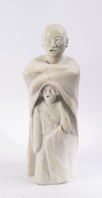 a statue of a man and a woman holding a baby
