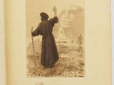 an old book with a picture of a man holding a stick