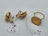 two pairs of gold earrings and a gold coin on a white surface