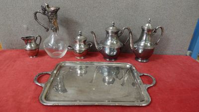 a silver tray with silverware on a red table cloth