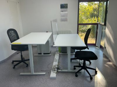 two desks and a chair in a room