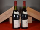 two bottles of wine sitting next to each other on a table