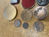 a lot of coins on a table with a stamper