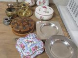 many plates and bowls on a table next to a stove