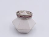 an image of a diamond and ruby ring on top of a white vase