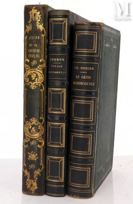 three books are stacked on top of each other on a white surface