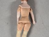 a doll that is laying on the floor next to a plate