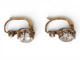 two pairs of gold and crystal earrings on a white background