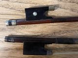 two pens sitting on top of a wooden table