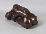 a figurine of a man laying down on the ground