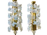 pair of brass and frosted glass sconces on a white background