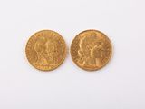 two gold sovereigns, one of which has a head of a man and the other of a woman