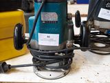 two electric tools on a table in a workshop