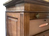 a wooden dresser with three drawers on it