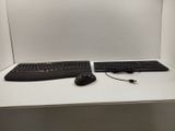 two keyboards and a mouse sitting on a desk
