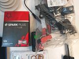 a box of spark plugs and other electronics on a table
