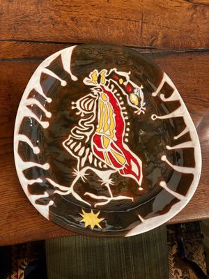 a plate with a design on it sitting on a table