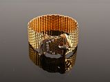 an image of a close up of a gold bracelet on a table